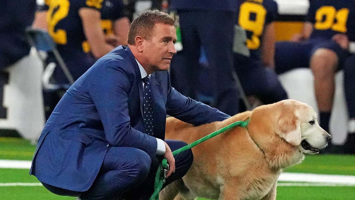 Kirk Herbstreit walks with his dog