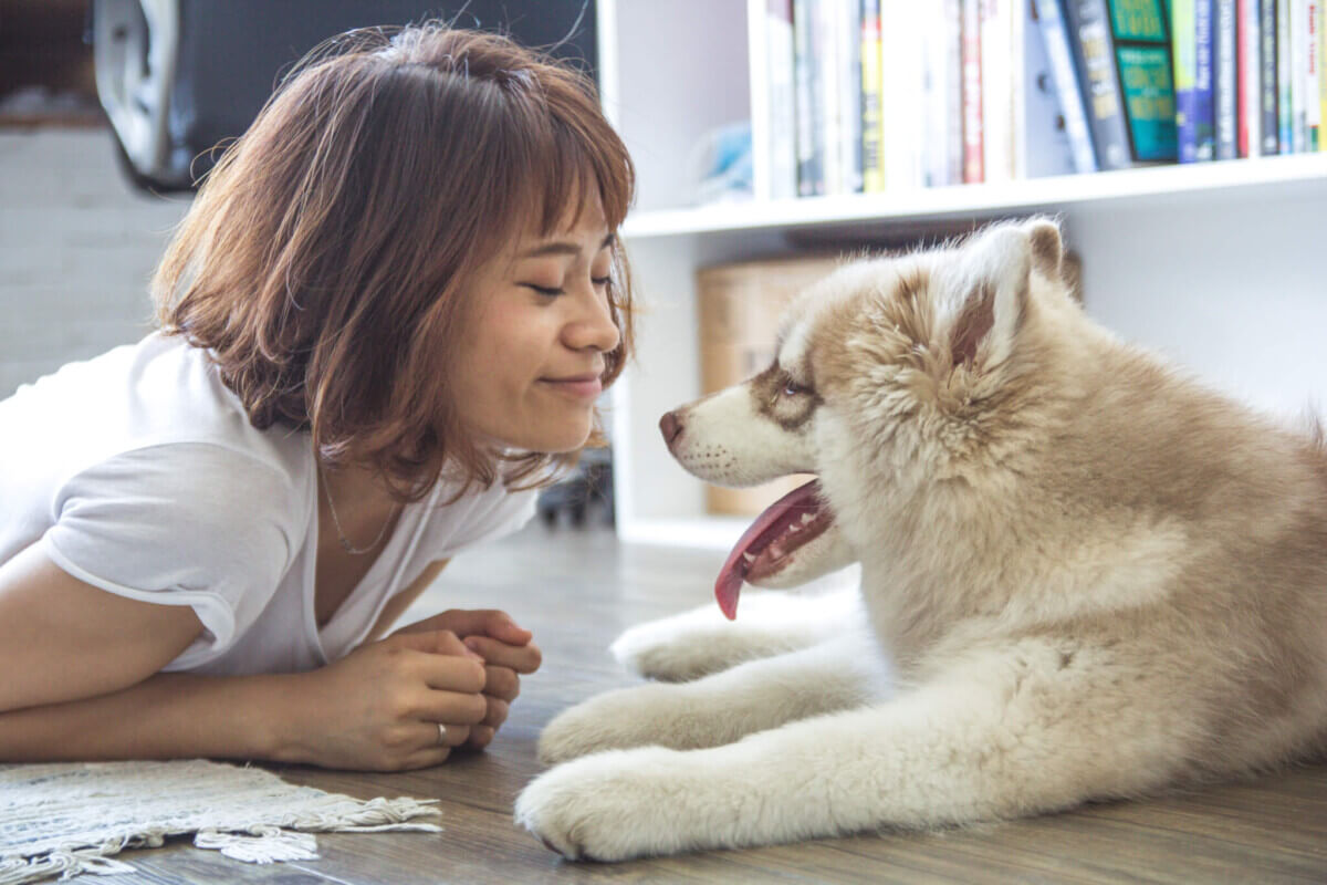 Woman smiling at her dog