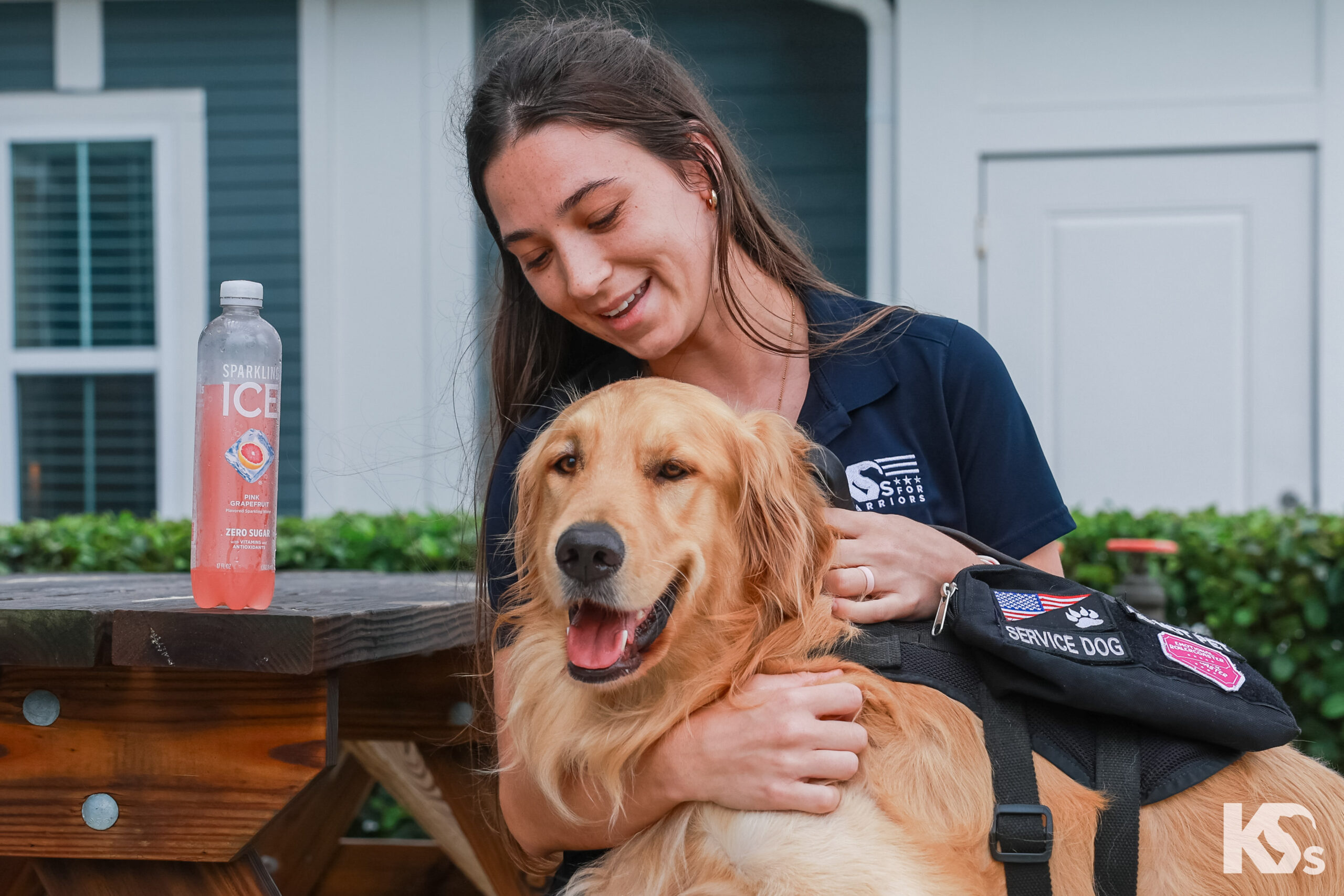 A service dog trainer at K9s For Warriors enjoys a refreshing bottle of Sparkling Ice.