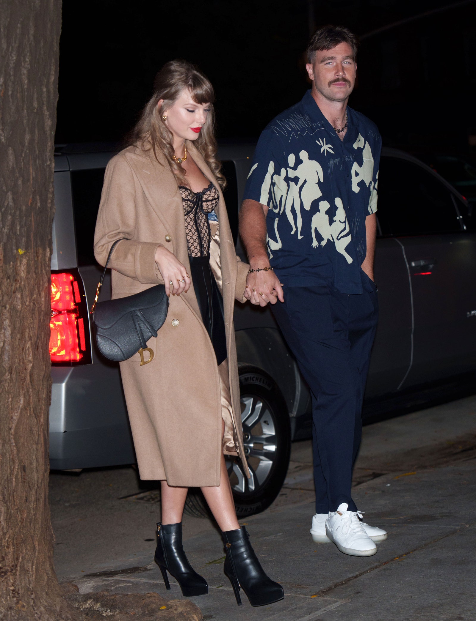 Image may contain Travis Kelce Taylor Swift Clothing Footwear Shoe Adult Person Accessories Bag and Handbag