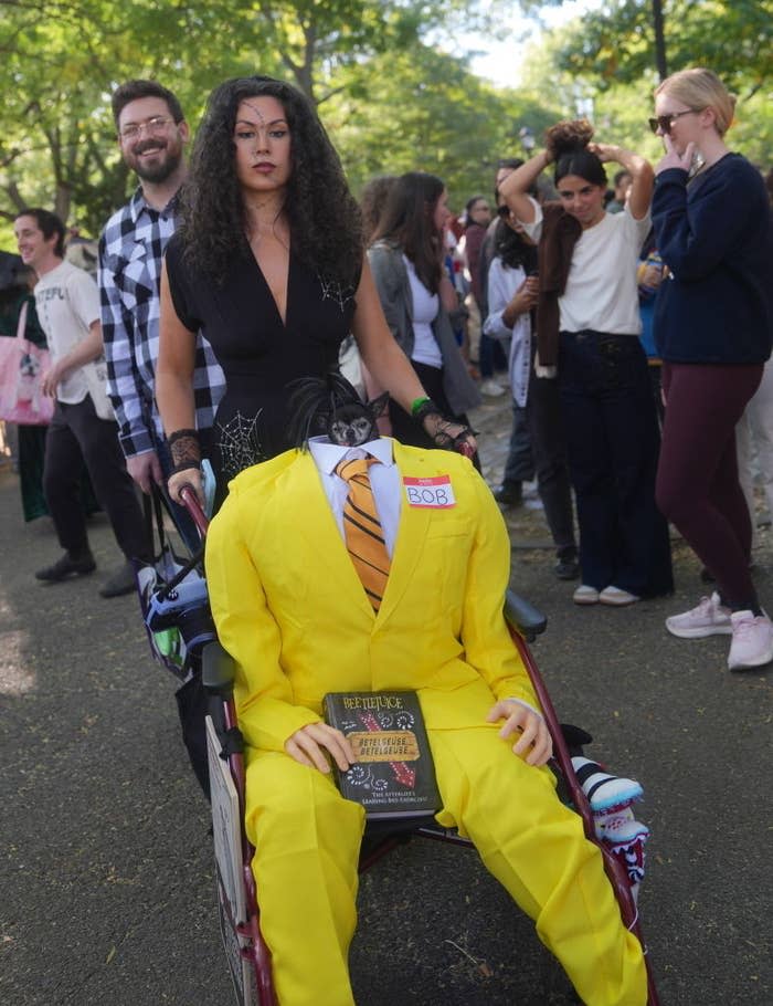 a woman with her dog dressed as a character from beetlejuice