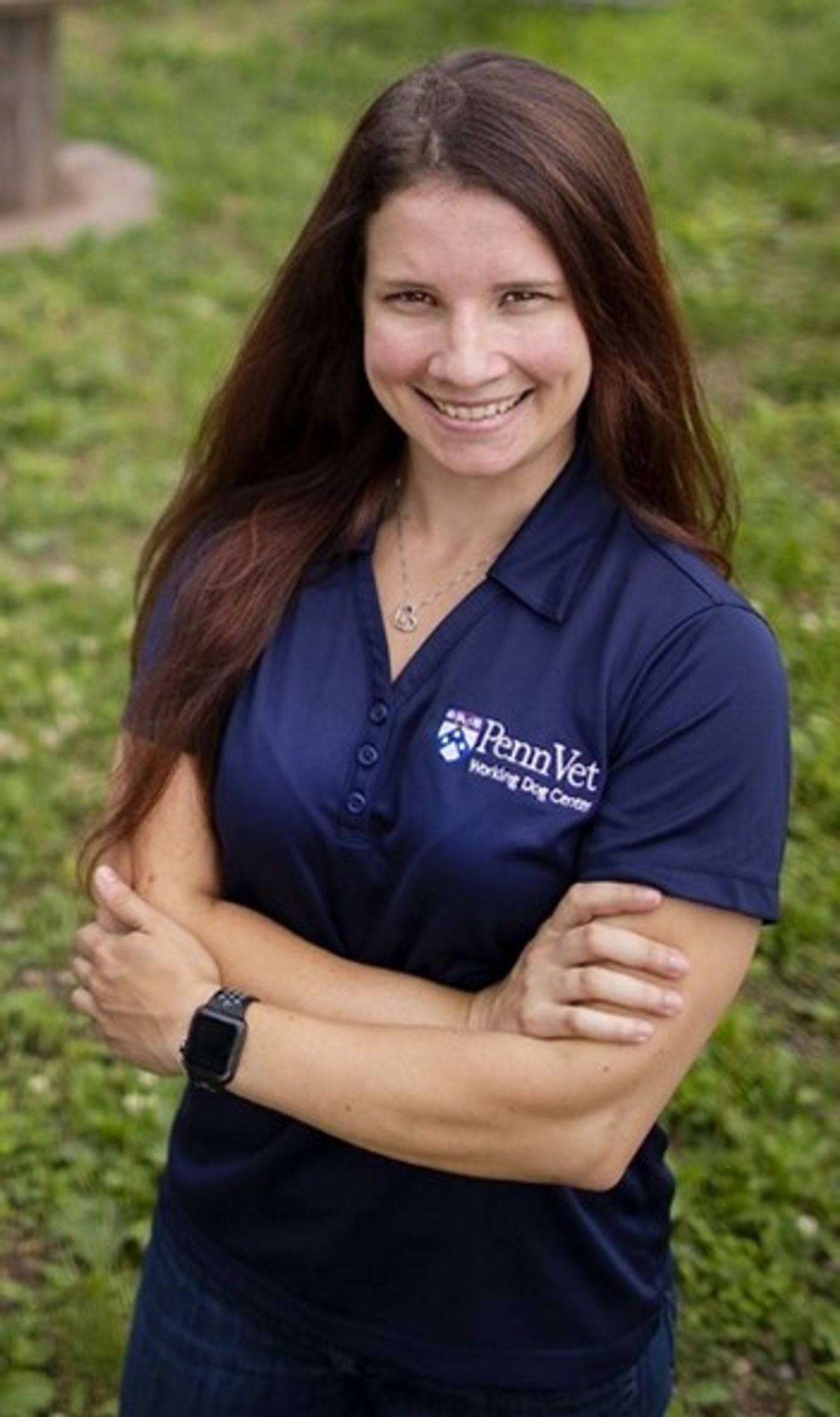 Headshot of Meghan Ramos, the medical director of the Penn Vet Working Dog Center and a lecturer of working dog sciences and sports medicine at the University of Pennsylvania’s School of Veterinary Medicine. She wears a blue t-shirt and has her arms folded in front of her.