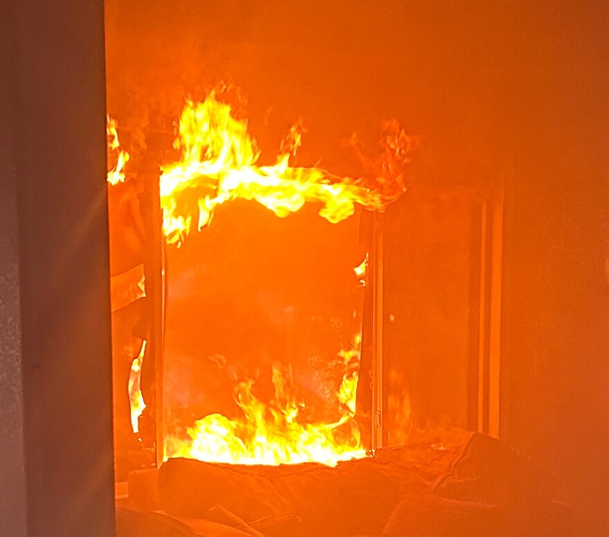 Flames seen through a burning doorway.