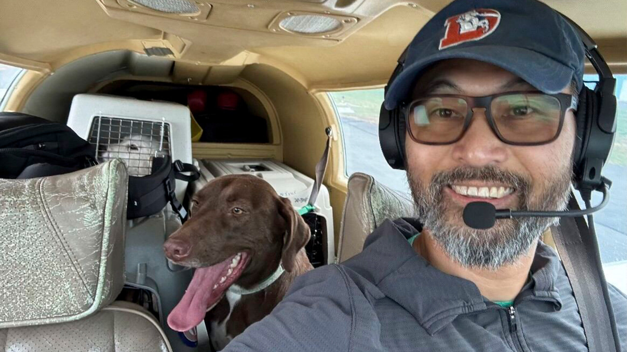 This photo released by The Animal Shelter of Schoharie Valley shows Seuk Kim during a flight to deliver dogs rescued from a euthanasia list to the Animal Shelter of Schoharie County on Nov. 11, 2024.