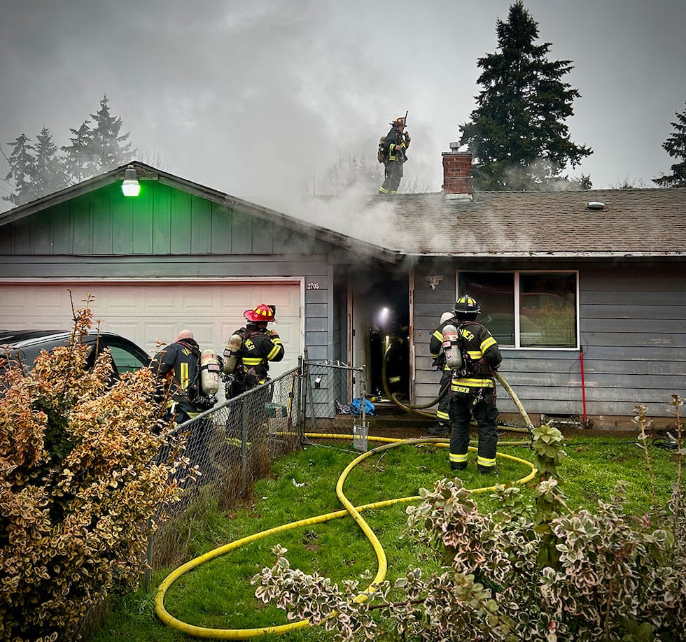 Firefighters extinguishing house fire