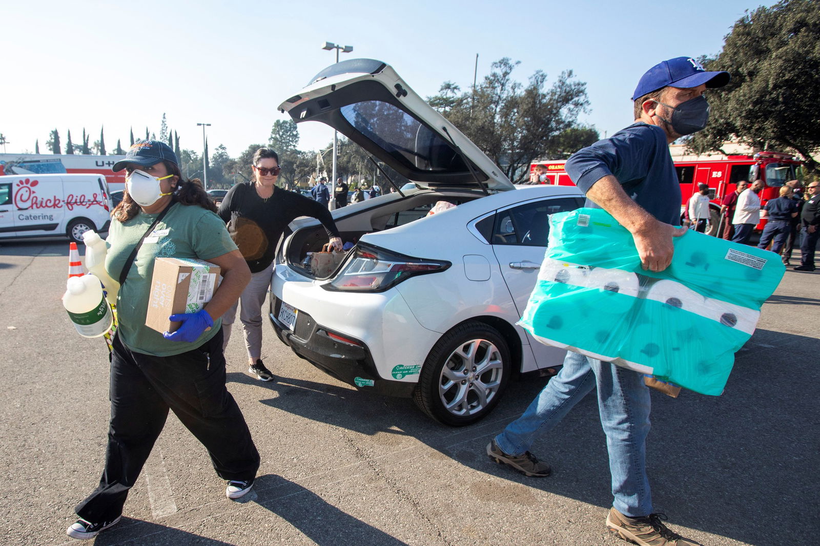 man helps carry toilet paper