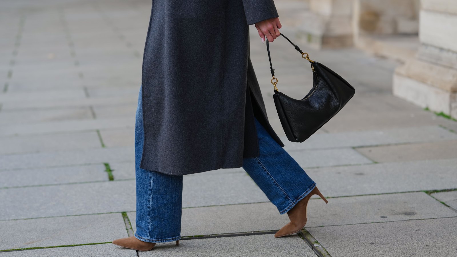 PARIS, FRANCE - DECEMBER 04: Allison Cardoso wears a black leather bag, a blue denim Levis jeans / pants, brown suede Potamy boots high heels, during a street style fashion photo session, on December 04, 2024 in Paris, France. (Photo by Edward Berthelot/Getty Images)