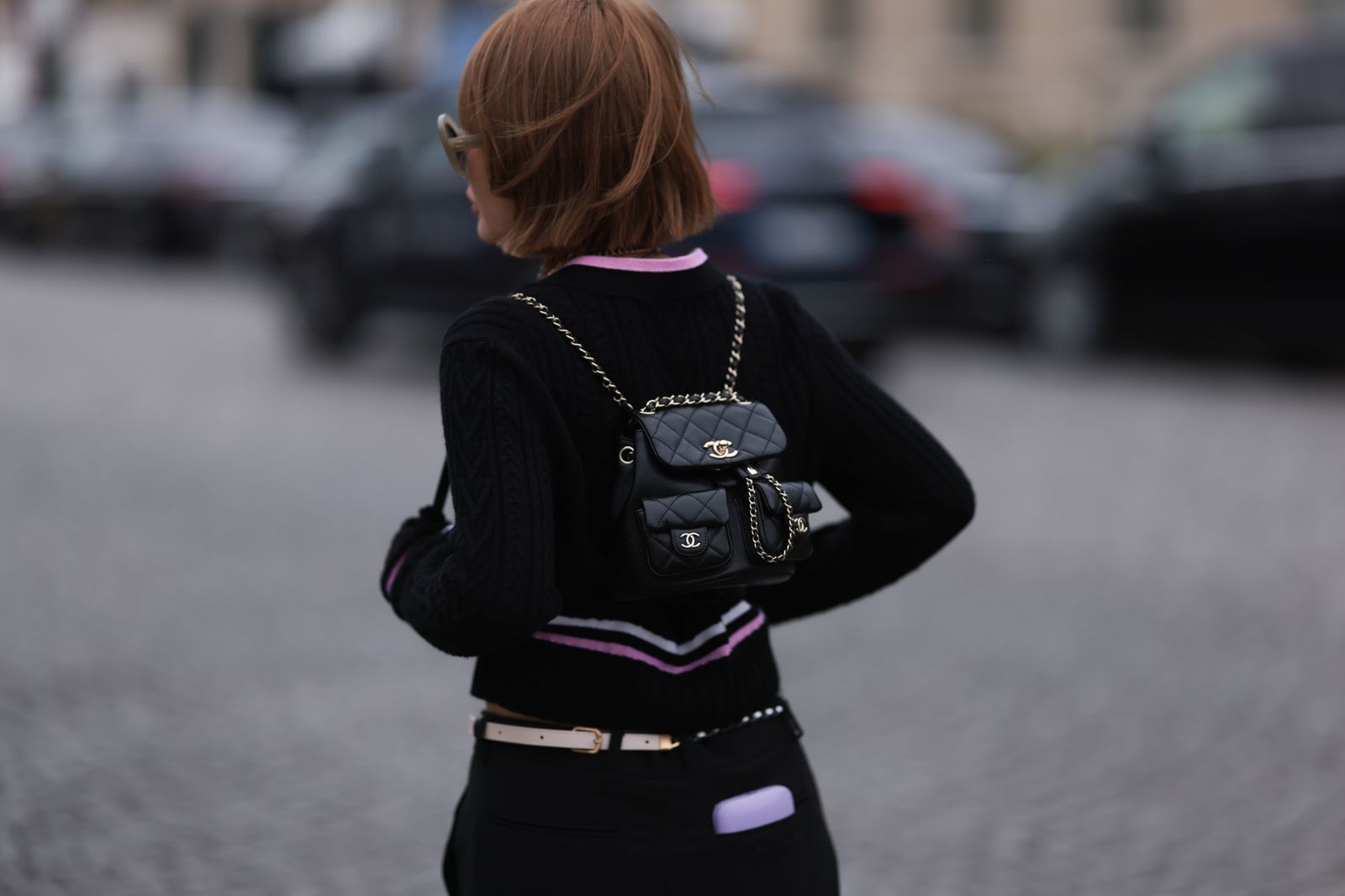 PARIS FRANCE  MARCH 07 A fashion week guest seen wearing a black nit cardigan a black skirt a black belt bag jewellery...