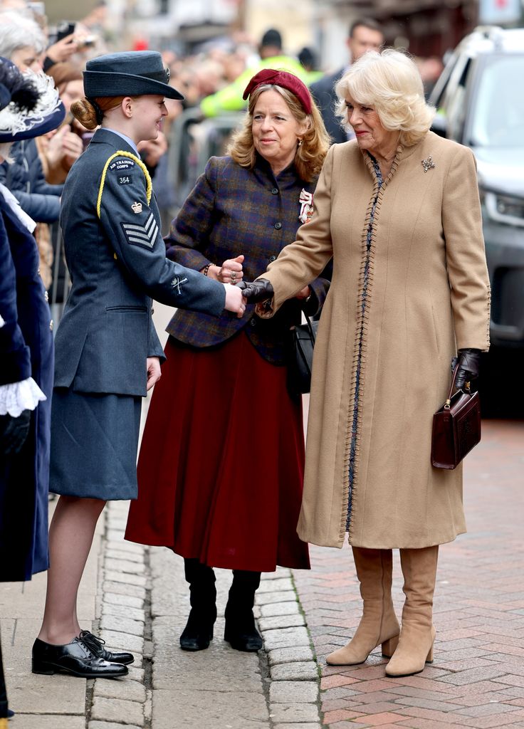 Queen Camilla shakes hands with a member o the military as she arrives for a visit to The Beaney House of Art & Knowledge on February 25, 2025 in Canterbury, England.