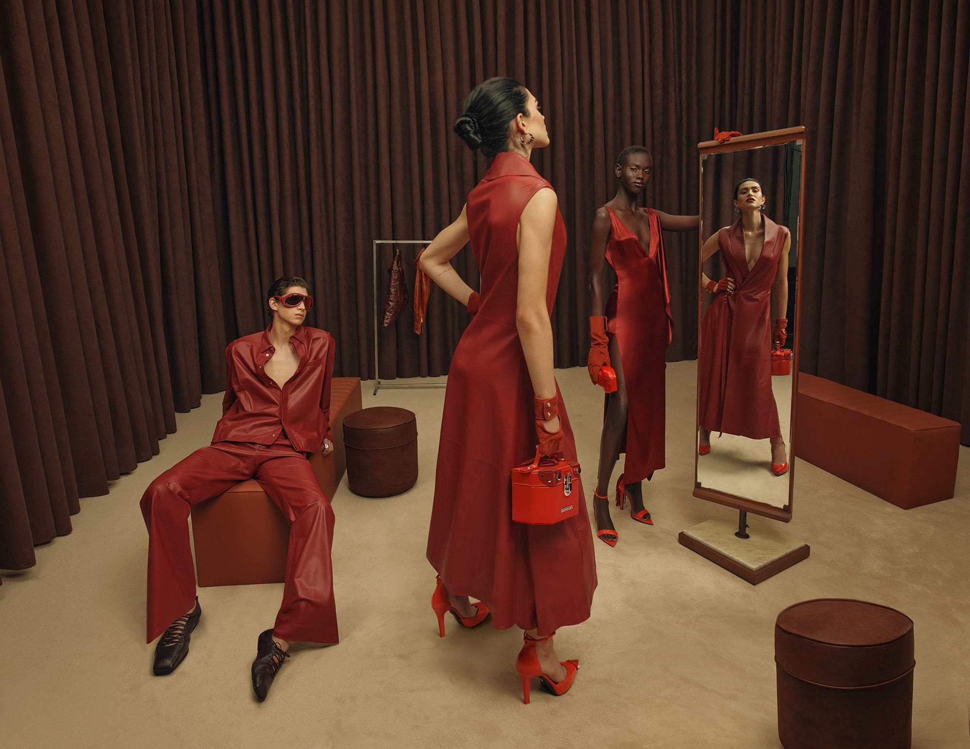 fashion display featuring models in red outfits in a styled interior