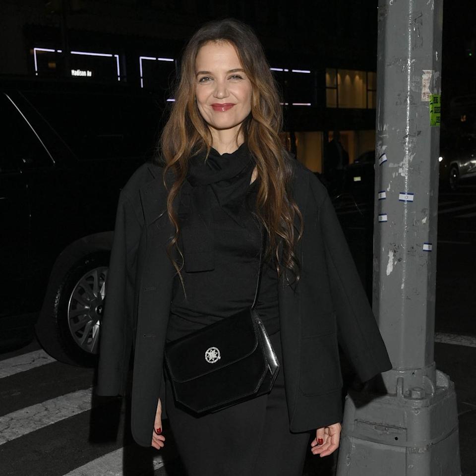  Katie Holmes attends a party for 11 Julliet bags with a leather handbag. 