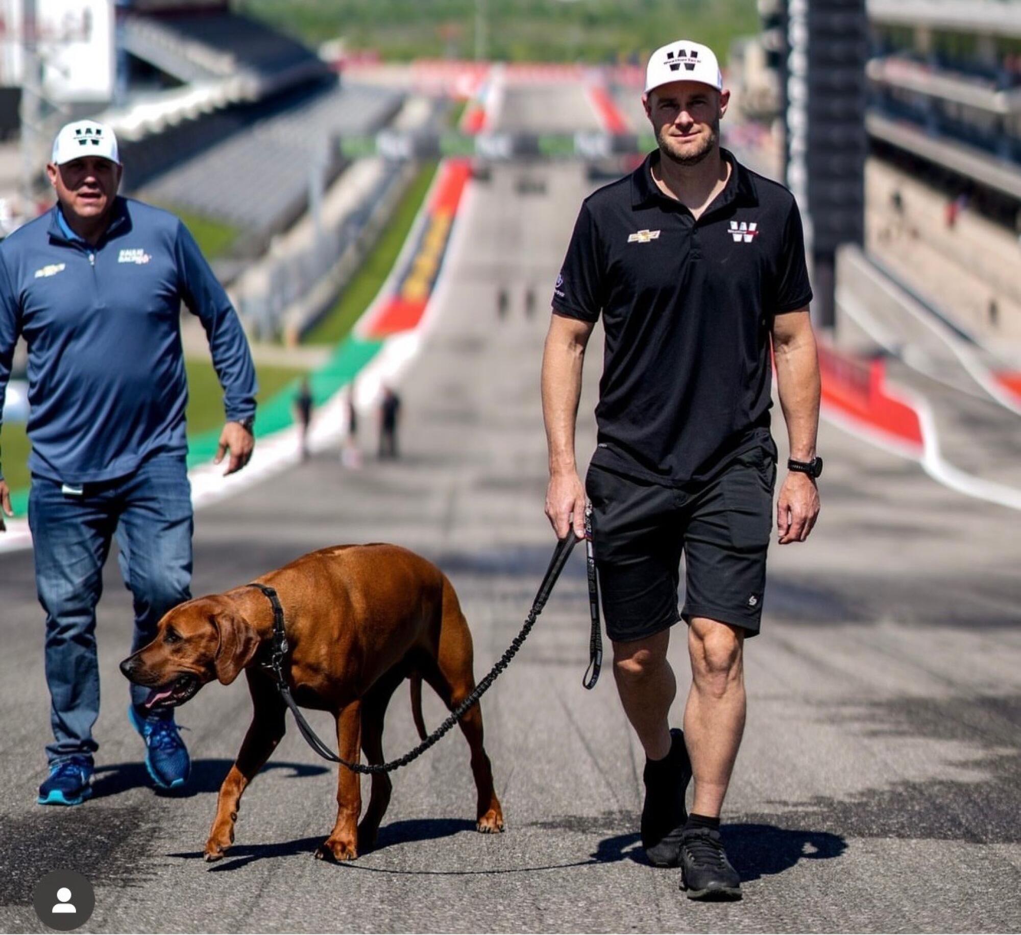 NASCAR driver Shane van Gisbergen walks his dog, Ronald, at Circuit of the Americas in Austin, Texas.
