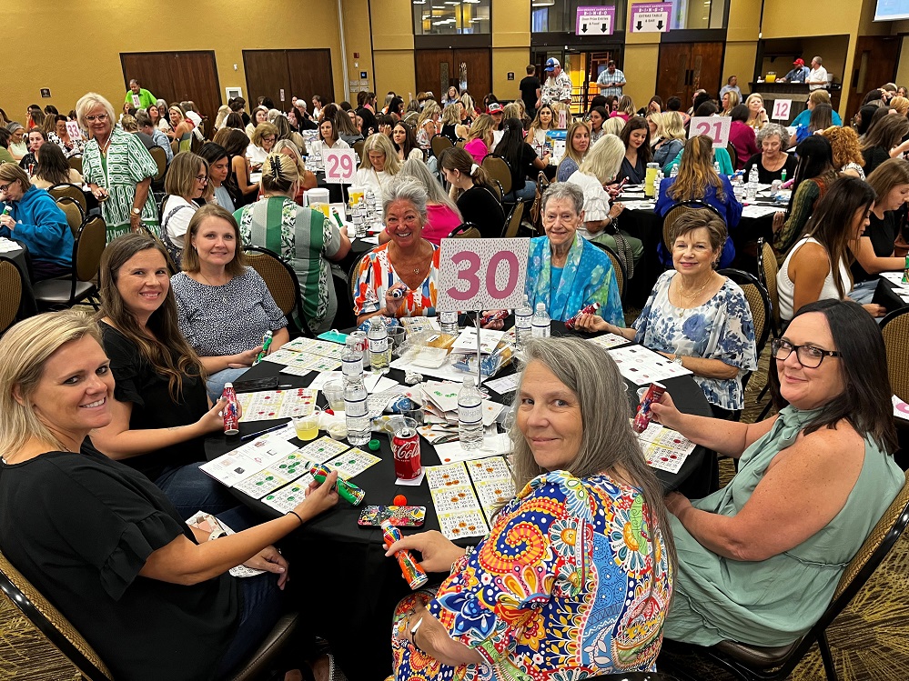 Photo: HC Health Care Foundation’s 6 th Annual Designer Handbag Bingo is set for August 7. Hundreds of ladies will play for the chance to win designer and luxury handbags. Pictured is the CMF-SS Volunteer Auxiliary table at the event from 2024. Sponsorships go on sale May 19 online at handbagbingo25.GiveSmart.com.