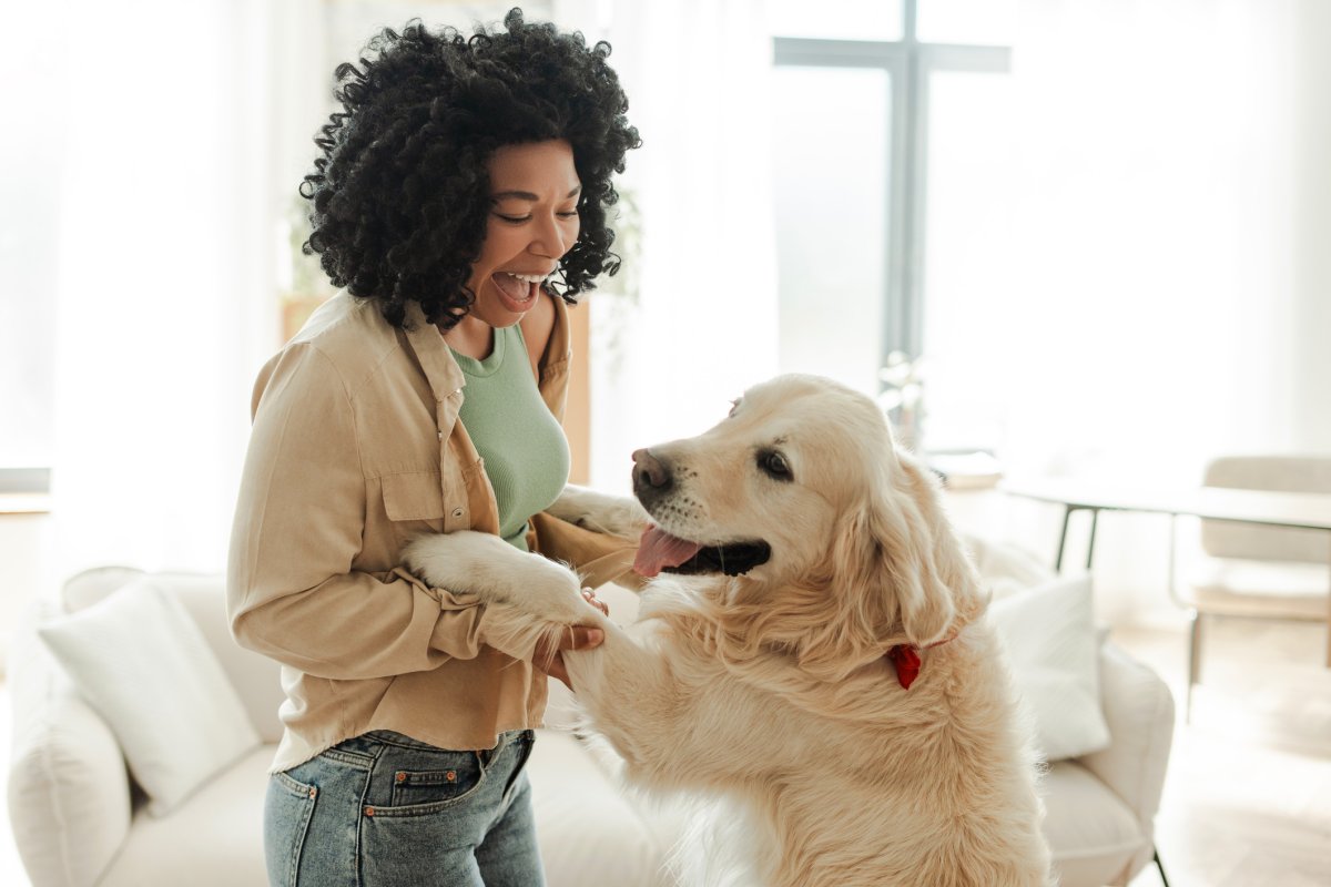A woman dances with her dog