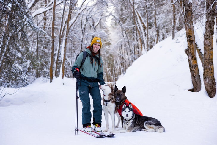 Skier and three dogs