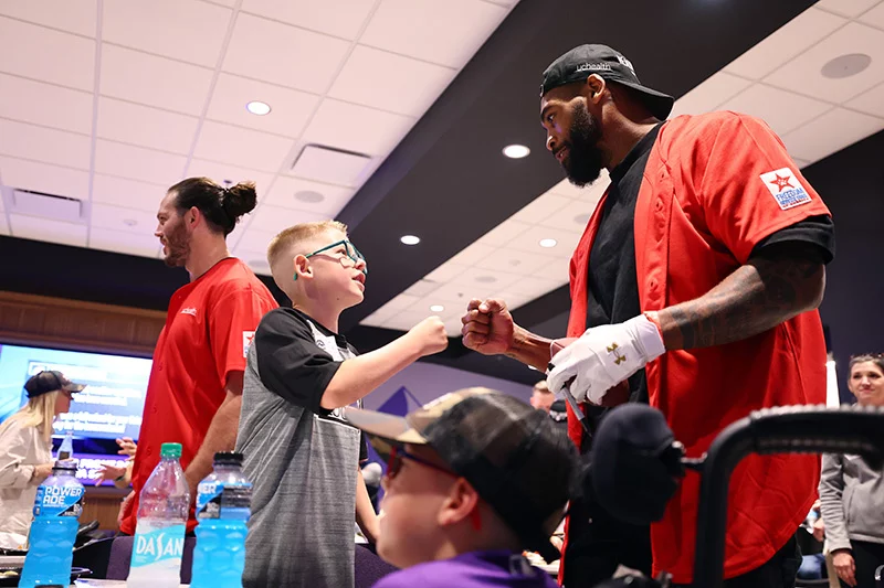 UCHealth donated $175,000 to Freedom Service Dogs following its annual charity home run derby, Healthy Swings. Denver football player, Jonathan Cooper, greeted families who benefit from Freedom Service Dogs. Photo by Jamie Scheaberow, Clarkson Creative Photography.